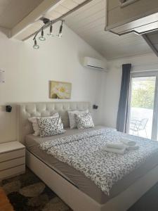 a bedroom with a large bed in a room at House Zupan in Rakovica
