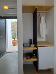 a kitchen with a white refrigerator and a door at Maria's Private Space - Mykonos in Ano Mera