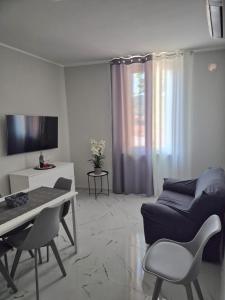 a living room with a couch and a table at Stornelli Suite & Apartments in Avezzano