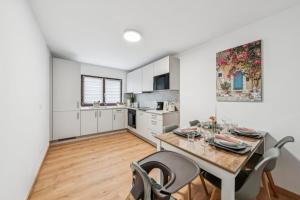 a kitchen and dining room with a table and chairs at SleepHaven in Walldürn