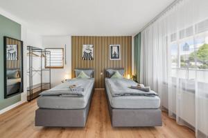 a bedroom with two beds and a window at SleepHaven in Walldürn +7 photos