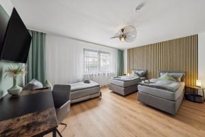 a living room with two couches and a table at SleepHaven in Walldürn