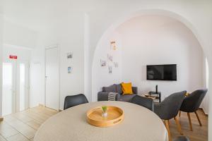 a living room with a table and a couch at Vista del Mar Guest House in Albufeira
