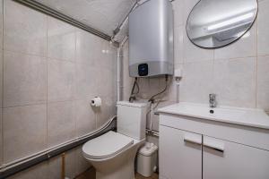 a bathroom with a toilet and a sink and a mirror at Vista del Mar Guest House in Albufeira +21 photos