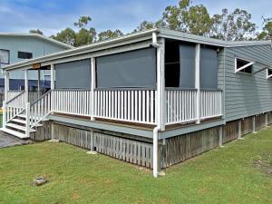 a modular home with a porch and windows at Brownies on Birch in Amity Point