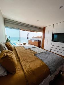 a bedroom with a large bed with a view of the ocean at Oceanview 2BR with Terrace in Punta Hermosa in Punta Hermosa