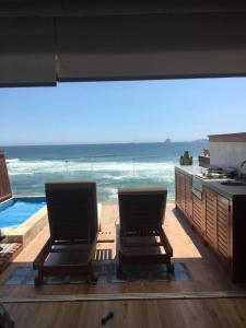 two chairs in a room with a view of the ocean at Oceanview 2BR with Terrace in Punta Hermosa in Punta Hermosa
