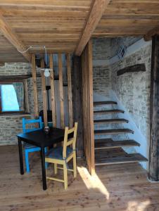 a dining room with a table and a staircase at Casa Vacanza in Serravalle delle Langhe