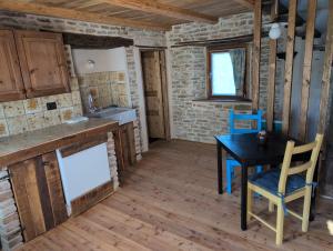 a kitchen and dining room with a table and chairs at Casa Vacanza in Serravalle delle Langhe