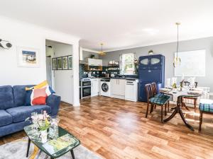a living room with a blue couch and a table at Kilmartin View in Lochgilphead +34 photos