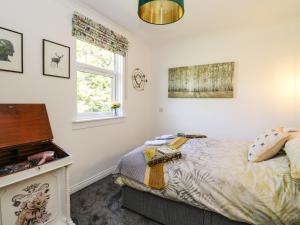 a bedroom with a bed and a piano at Kilmartin View in Lochgilphead