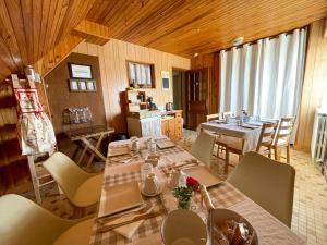 a dining room with a table and some chairs at La maison du pont du gué in Bourgueil