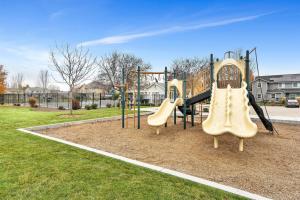 a playground with two slides in a park at Highland Haven by Settler's Park in Meridian