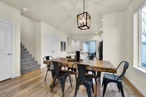 a dining room with a wooden table and chairs at Highland Haven by Settler's Park in Meridian +35 photos