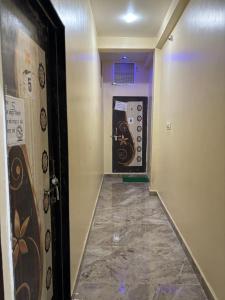 a hallway with a door with a tile floor at Sanatan lok in Ujjain
