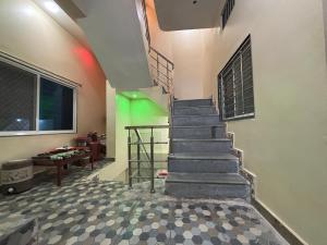 a staircase in a room with a green light at Sanatan lok in Ujjain