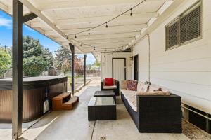 a patio with a couch and a hot tub at Poolside Paradise with Hot Tub in Boise +37 photos