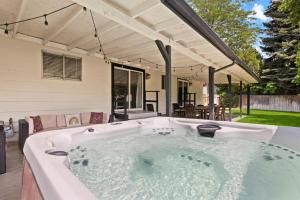 a hot tub in the backyard of a house at Poolside Paradise with Hot Tub in Boise
