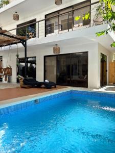 an empty swimming pool in front of a house at Encantador Loft con Piscina 1 BDR in Santa Teresa Beach