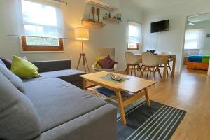 a living room with a couch and a table at Saltys Amity Point in Amity Point