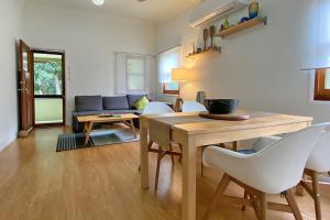 a living room with a table and chairs and a couch at Saltys Amity Point in Amity Point