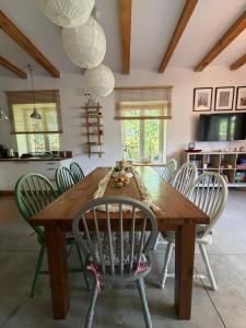 a dining room with a wooden table and chairs at Siedlisko Dębinka in Miłomłyn