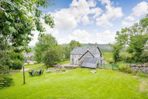an image of a house in a field with a yard at Smithy House in Lochgilphead