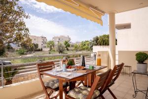 a table and chairs on a balcony with a view at Captain's Corner in Markopoulo