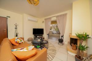 a living room with a couch and a fireplace at Captain's Corner in Markopoulo