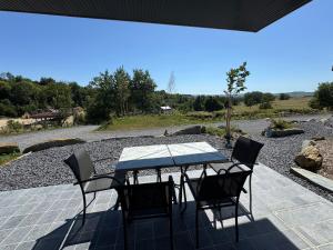 a table and chairs sitting on a patio at Brin d'Air Lodge in Montcornet