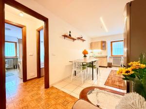 a living room with a table and a kitchen at Casa di Mary in Châtillon
