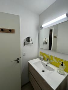 a bathroom with a sink and a mirror at Les jardins de la Méditerranée in Six-Fours-les-Plages +24 photos