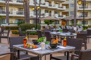 an outdoor dining area with tables and chairs at Villa del Palmar Beach Resort & Spa Puerto Vallarta in Puerto Vallarta