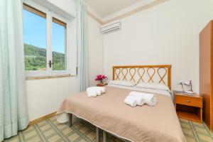 a bedroom with a bed with towels on it at Hotel Royal in Villammare +41 photos