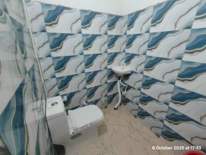 a bathroom with a sink and a toilet at Gopal Sadan-2 in Vrindāvan