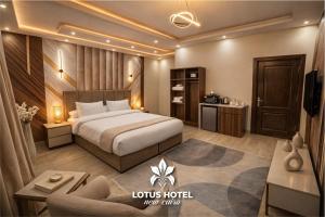 a hotel room with a bed and a couch at Lotus Hotel - Golden Square in Cairo