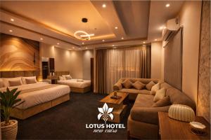 a hotel room with two beds and a couch at Lotus Hotel - Golden Square in Cairo