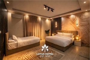 a hotel room with two beds in a room at Lotus Hotel - Golden Square in Cairo +5 photos