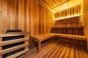 a wooden sauna with a wooden bench in it at Luxury Beachfront 3BR Apt 102 | Neea Bahia Soliman in Balcheil +46 photos