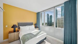 a bedroom with a bed and a large window at Sentral Michigan Avenue in Chicago
