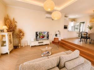 a living room with a couch and a tv at Jeju Semo, Byeol in Seogwipo