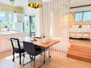 a kitchen and dining room with a table and chairs at Jeju Semo, Byeol in Seogwipo