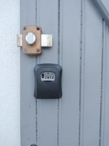 a padlock on a metal door with a wall at La Trimouillaise in La Trimouille +18 photos