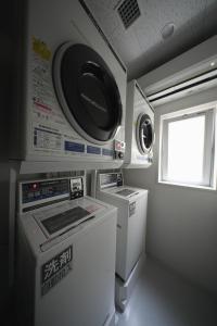 a small kitchen with a washer and dryer at da Haus Shinjuku in Tokyo