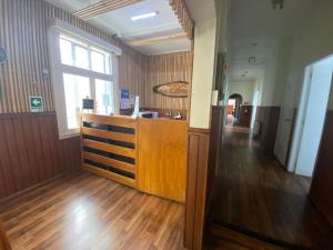 an empty room with a wooden counter and a window at Hostal Ochen in Punta Arenas