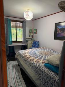 a bedroom with a bed and a window at My Caribe Casa in Puerto Viejo