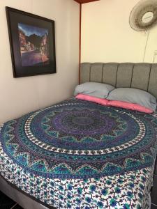 a bed with a quilt on it in a bedroom at My Caribe Casa in Puerto Viejo