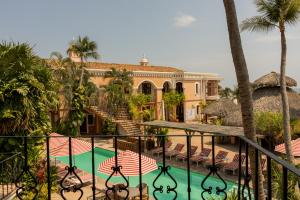 a house with a swimming pool in front of a house at Hotel Santa Fe in Puerto Escondido