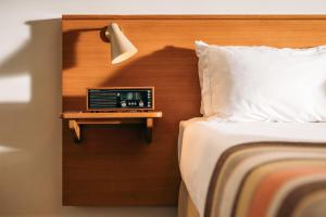 a bedroom with a bed and a clock on a wall at Hotel Meudon in Falmouth