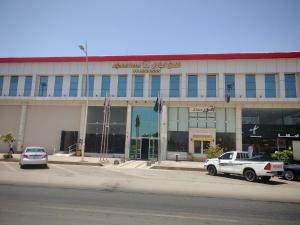 a large building with cars parked in front of it at فندق الجادل Al Jadel Hotel in Al Kharj